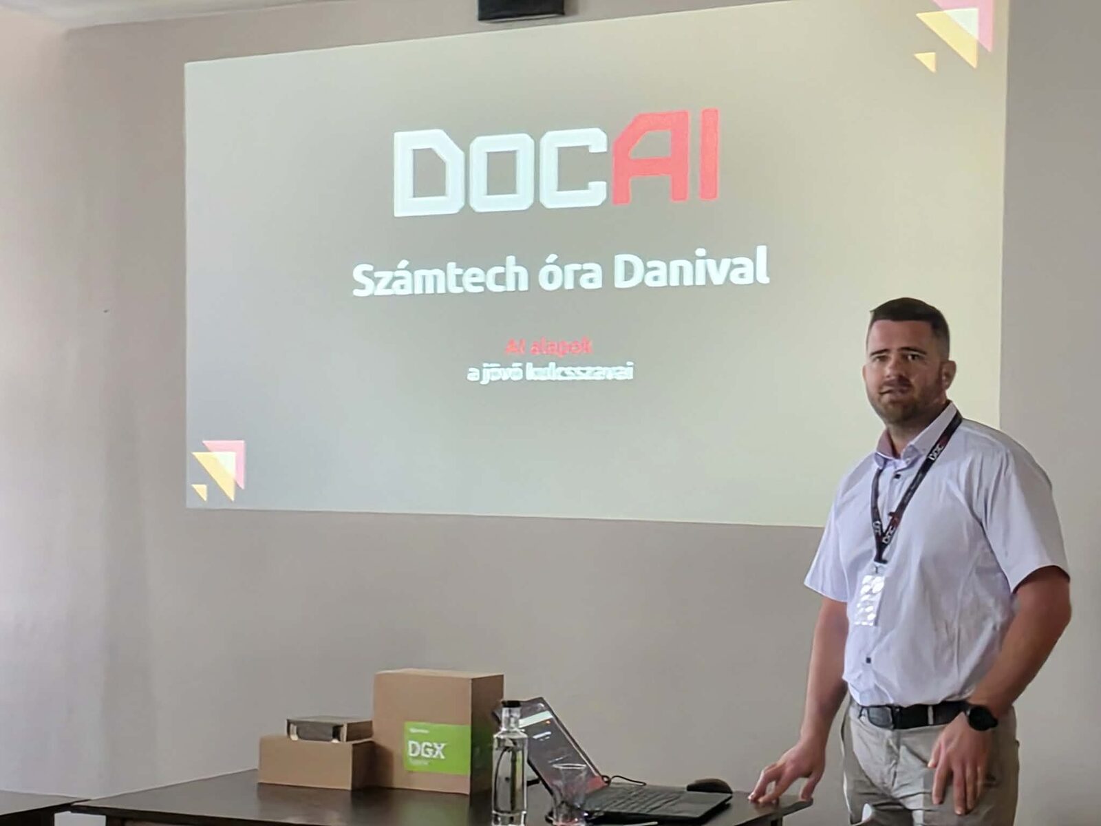 Dániel Kiss during the &ldquo;Computer science class with Dani&rdquo; talk at the first DocIT/DocAI partner meeting &mdash; the switched-off NVIDIA DGX Spark on the table.
